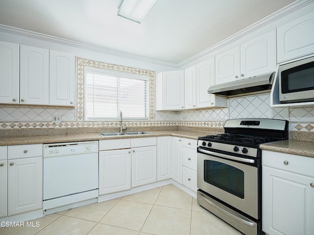 kitchen with sink, light tile patterned floors, stainless steel appliances, and white cabinets