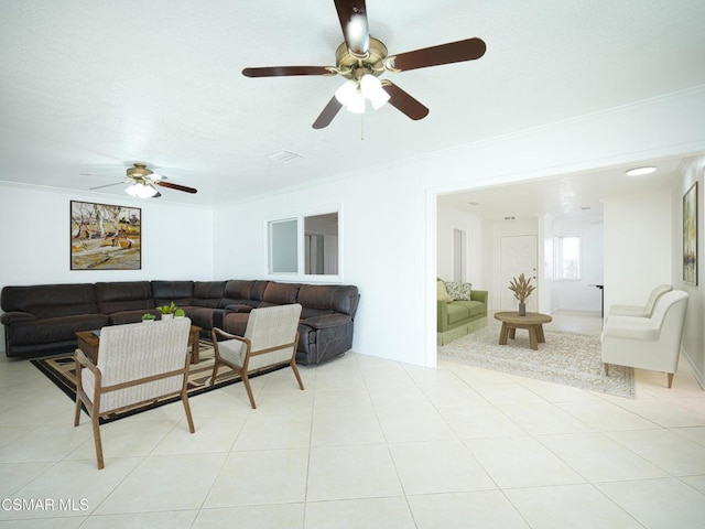 living room featuring light tile patterned floors and crown molding