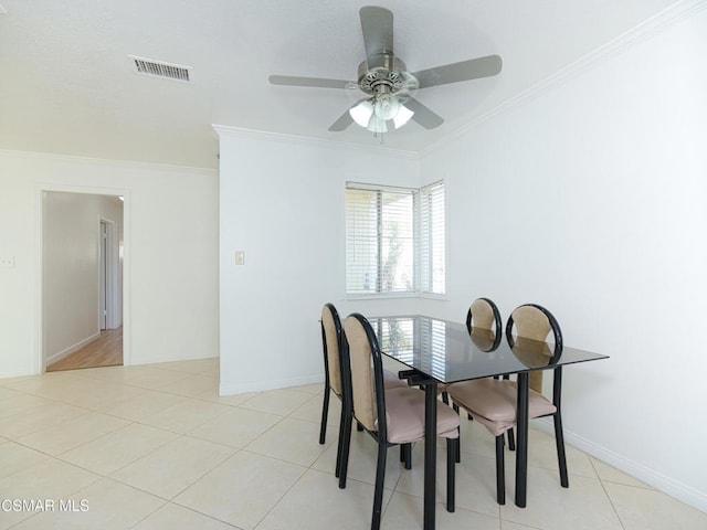 dining room featuring ornamental molding, light tile patterned flooring, and ceiling fan