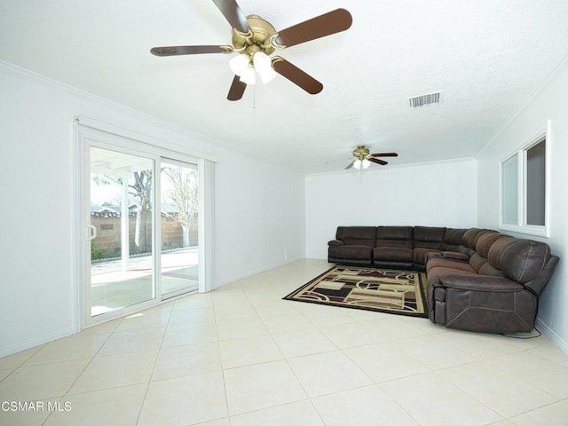 living room featuring crown molding, ceiling fan, and light tile patterned flooring