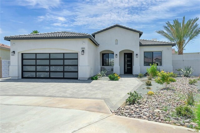 mediterranean / spanish-style house with a garage