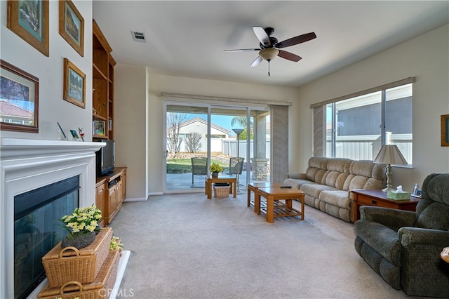 carpeted living room featuring ceiling fan