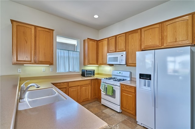 kitchen with white appliances and sink