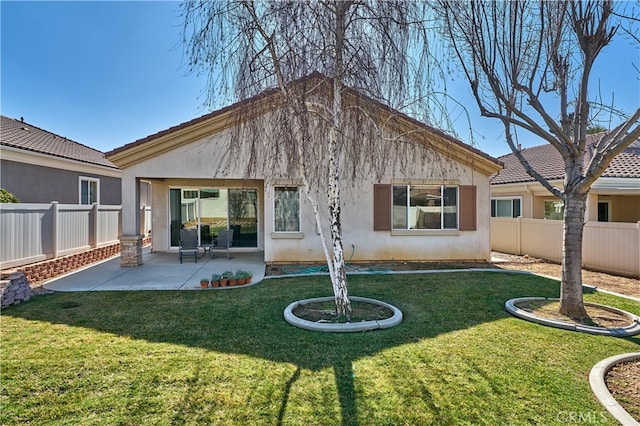 back of property with a patio and a lawn