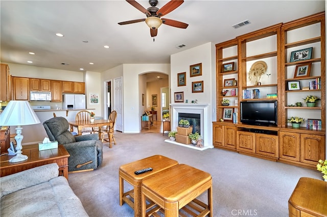 carpeted living room featuring ceiling fan