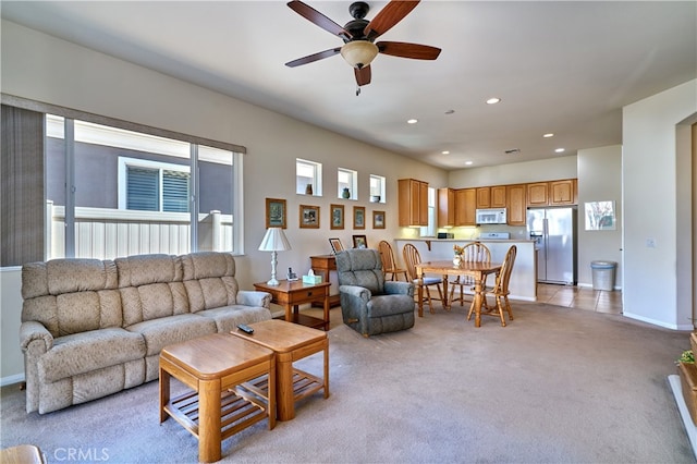 carpeted living room with ceiling fan