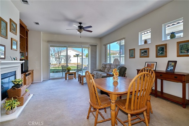 dining room featuring light colored carpet and ceiling fan