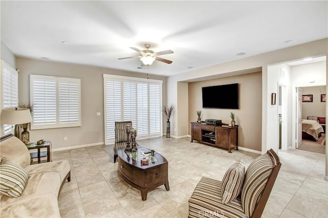 living room with ceiling fan and light tile patterned flooring