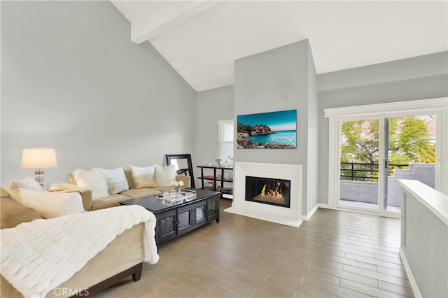 living room featuring hardwood / wood-style floors, high vaulted ceiling, and beamed ceiling