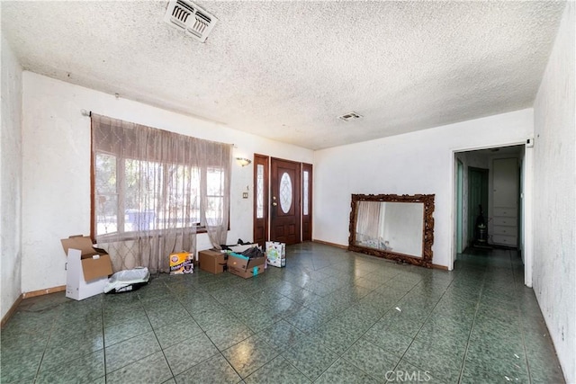 foyer entrance featuring a textured ceiling