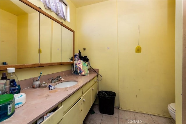 bathroom featuring vanity, tile patterned floors, and toilet