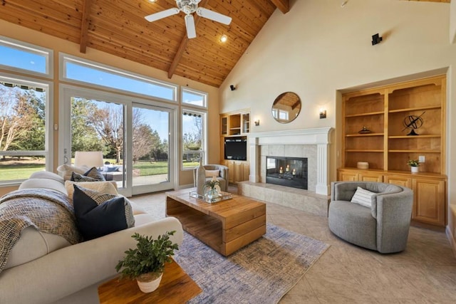 tiled living room featuring a tile fireplace, high vaulted ceiling, beamed ceiling, ceiling fan, and wood ceiling