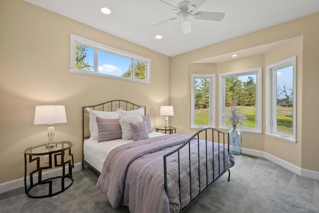 bedroom featuring ceiling fan and dark colored carpet