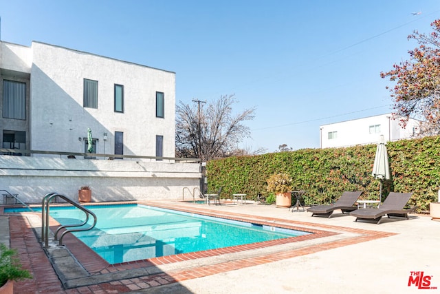 view of swimming pool with a patio area