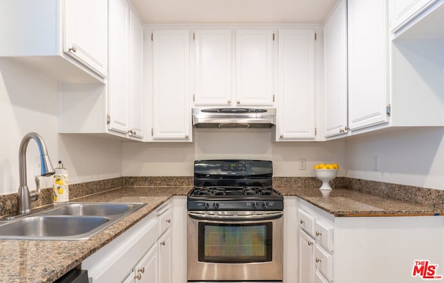 kitchen with dishwashing machine, sink, stainless steel gas stove, dark stone countertops, and white cabinets