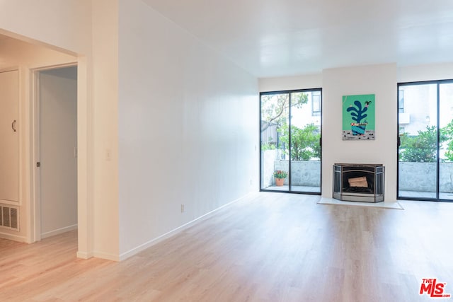 unfurnished living room with plenty of natural light and light wood-type flooring