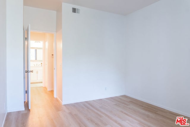 spare room with light hardwood / wood-style flooring