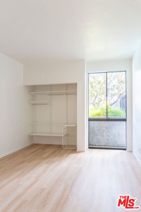 unfurnished bedroom featuring hardwood / wood-style flooring