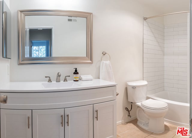 full bathroom with vanity, toilet, tiled shower / bath combo, and tile patterned flooring