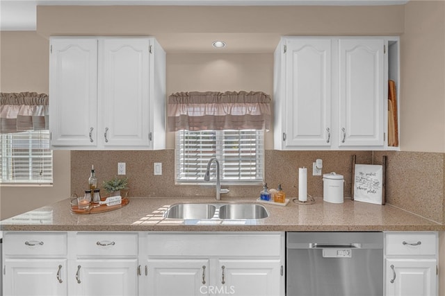 kitchen featuring white cabinetry, dishwasher, sink, and backsplash