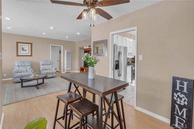 dining area featuring ceiling fan and light wood-type flooring