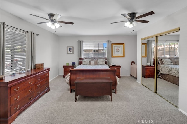 bedroom featuring light carpet, a closet, and ceiling fan