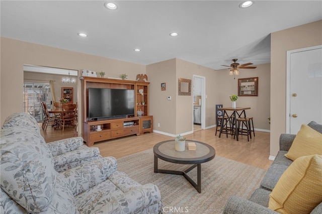 living room featuring ceiling fan and light hardwood / wood-style flooring