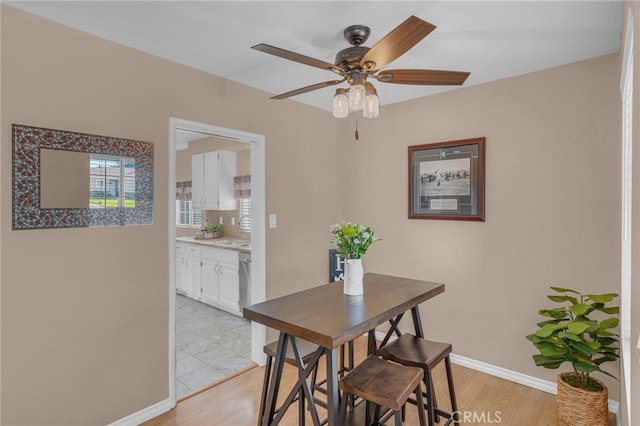 dining space featuring ceiling fan and light hardwood / wood-style floors