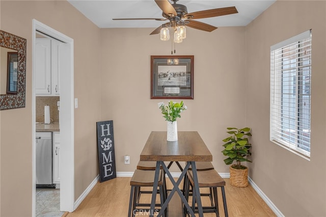 dining area featuring a healthy amount of sunlight, ceiling fan, and light hardwood / wood-style flooring