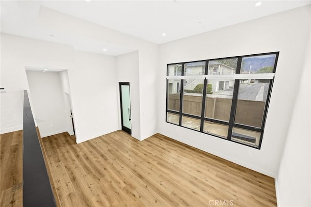 empty room with light hardwood / wood-style flooring