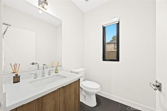 bathroom featuring tile patterned floors, vanity, and toilet