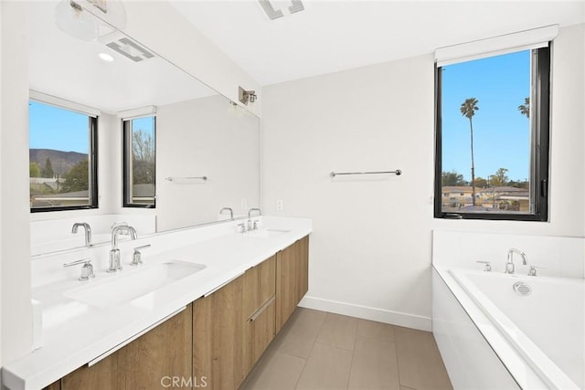 bathroom featuring vanity and a bath