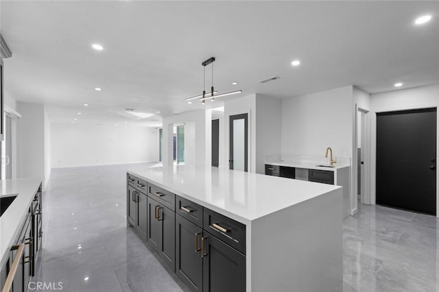 kitchen with pendant lighting, sink, and a center island