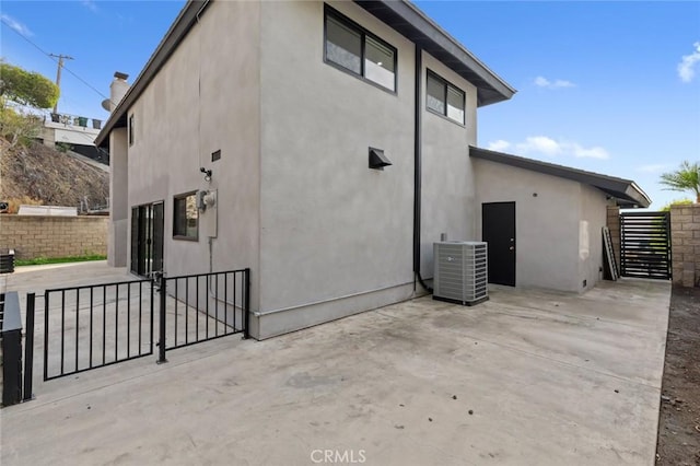 exterior space with a patio and central AC