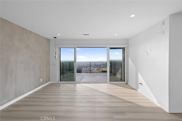 spare room featuring light hardwood / wood-style floors