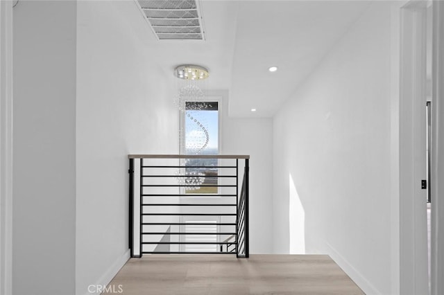 staircase with hardwood / wood-style floors