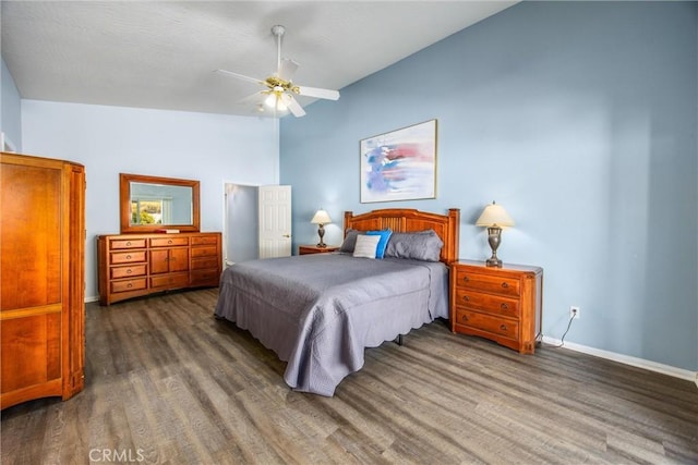 bedroom with dark wood-type flooring, ceiling fan, and vaulted ceiling