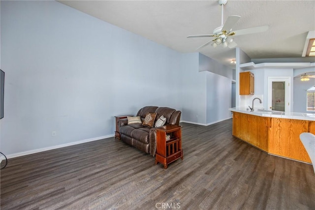 sitting room with ceiling fan and dark hardwood / wood-style flooring