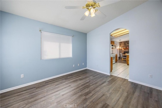 unfurnished room with hardwood / wood-style floors, vaulted ceiling, and ceiling fan