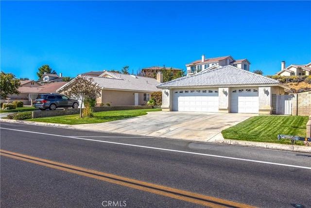 view of front of house featuring a garage and a front yard