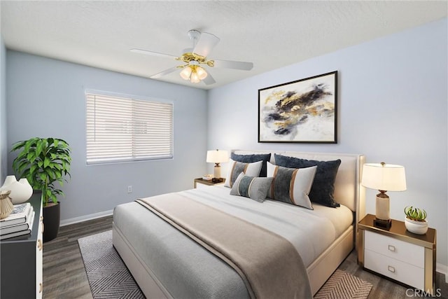 bedroom with dark hardwood / wood-style flooring and ceiling fan