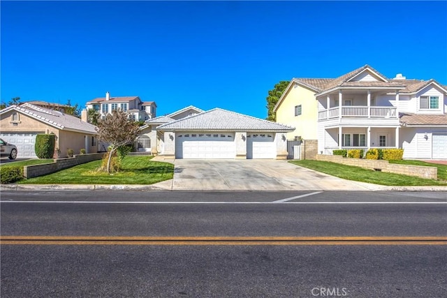 view of front of house featuring a garage and a front lawn