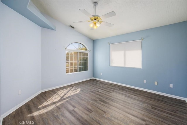 spare room featuring lofted ceiling, dark hardwood / wood-style floors, and ceiling fan