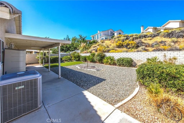 view of yard featuring central AC and a patio