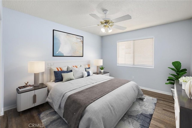 bedroom with dark hardwood / wood-style flooring and ceiling fan