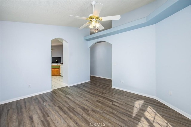 empty room featuring hardwood / wood-style floors and ceiling fan