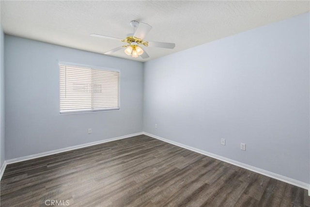 empty room with dark wood-type flooring and ceiling fan