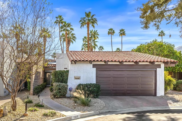 mediterranean / spanish-style house with a garage