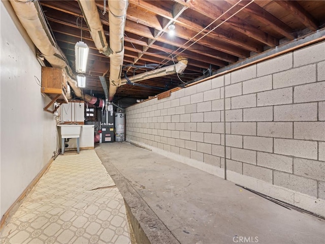 basement with water heater and sink