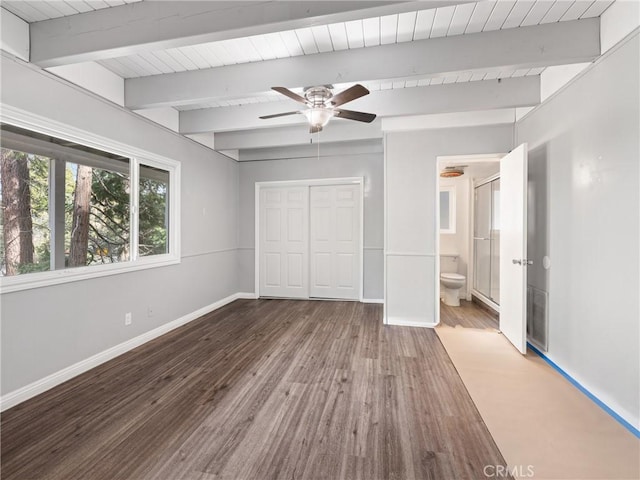 unfurnished bedroom featuring wood ceiling, beam ceiling, wood-type flooring, and a closet